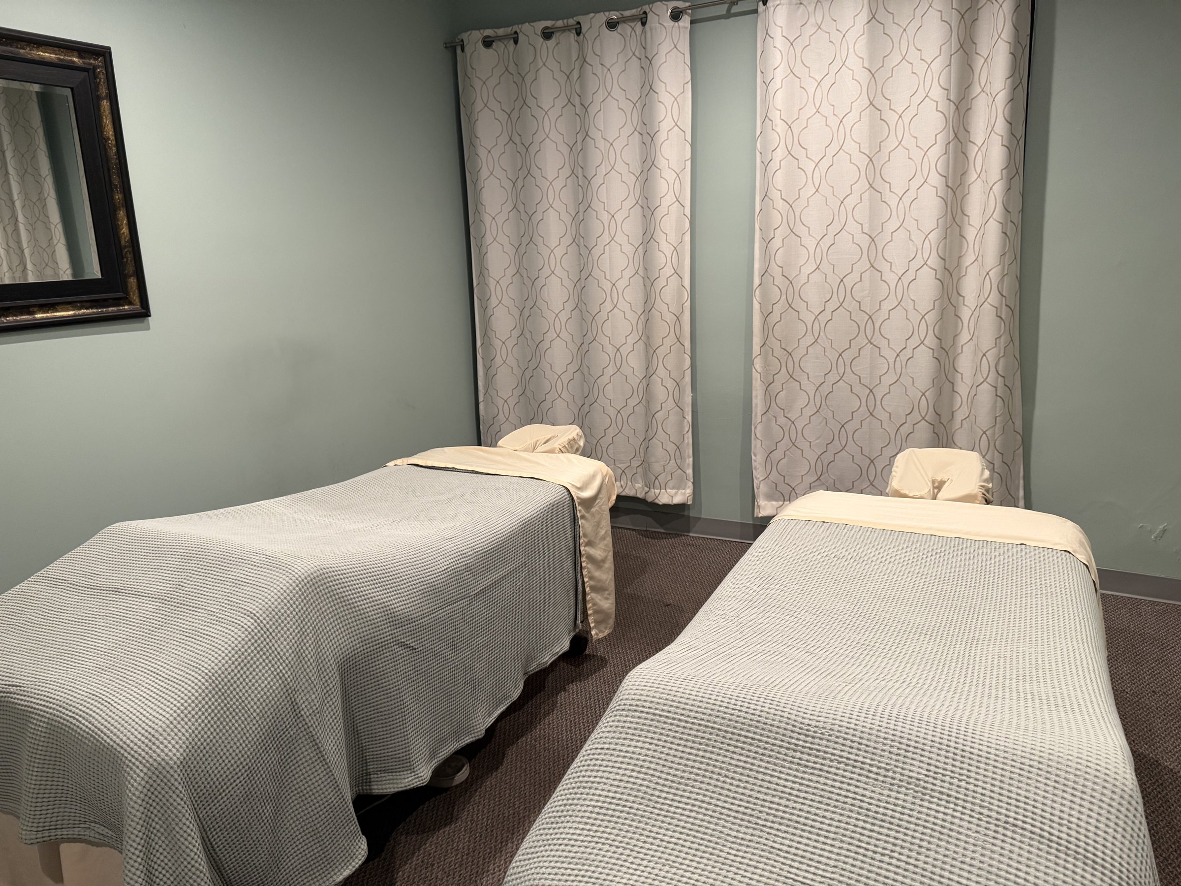 Two massage tables side by side in the couples room at Spa Flow Studio